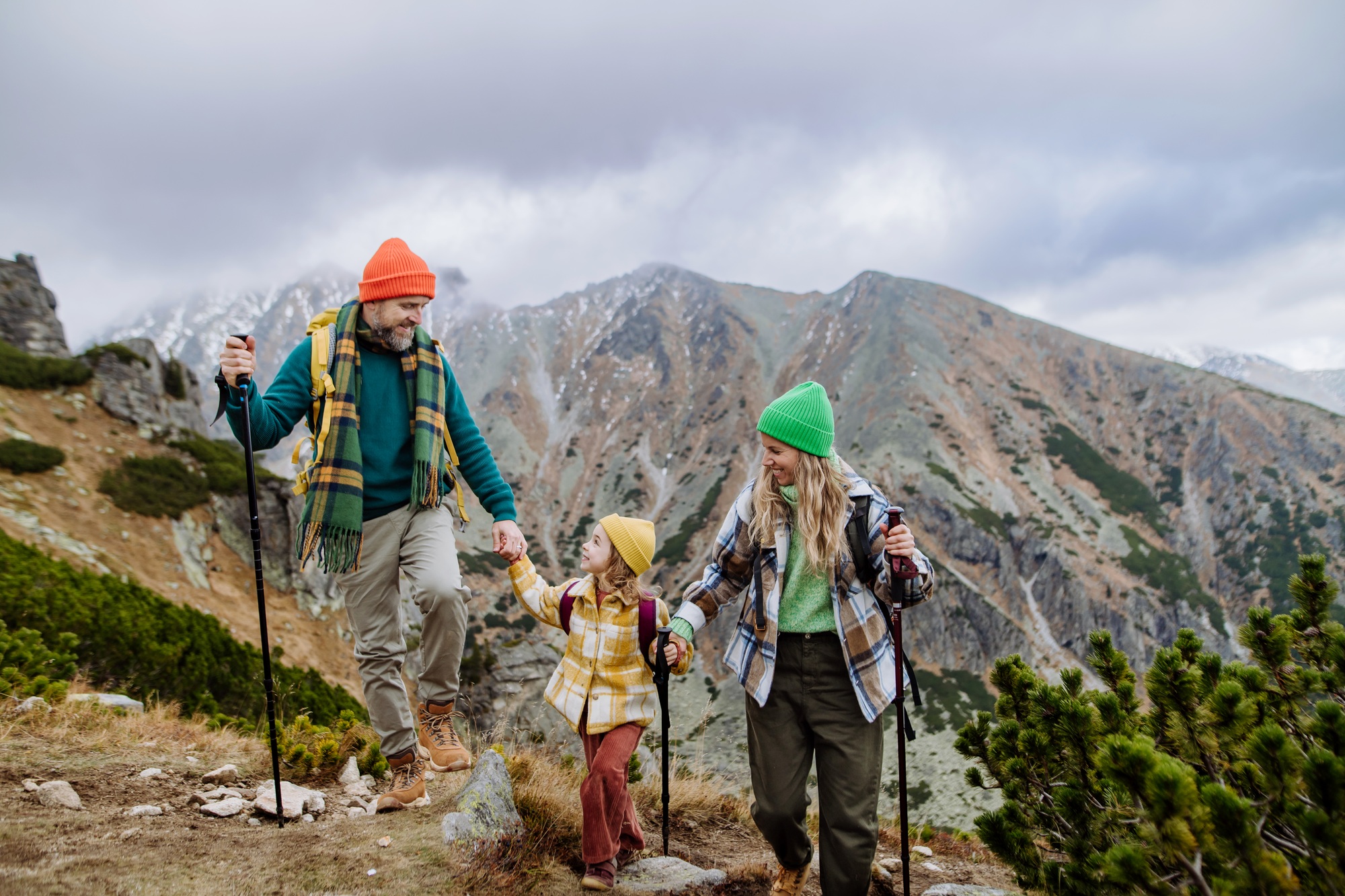 Happy family hiking together in autumn mountains.